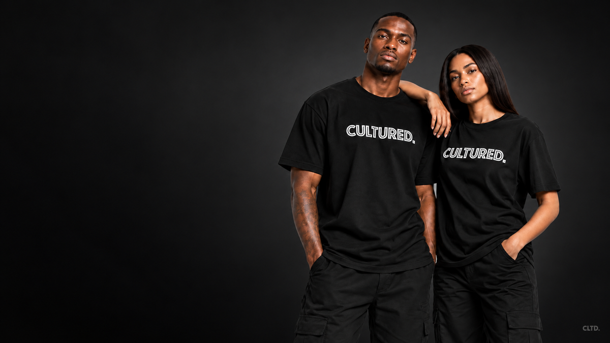 Two models wearing original black CULTURED. tees against a dark editorial background.