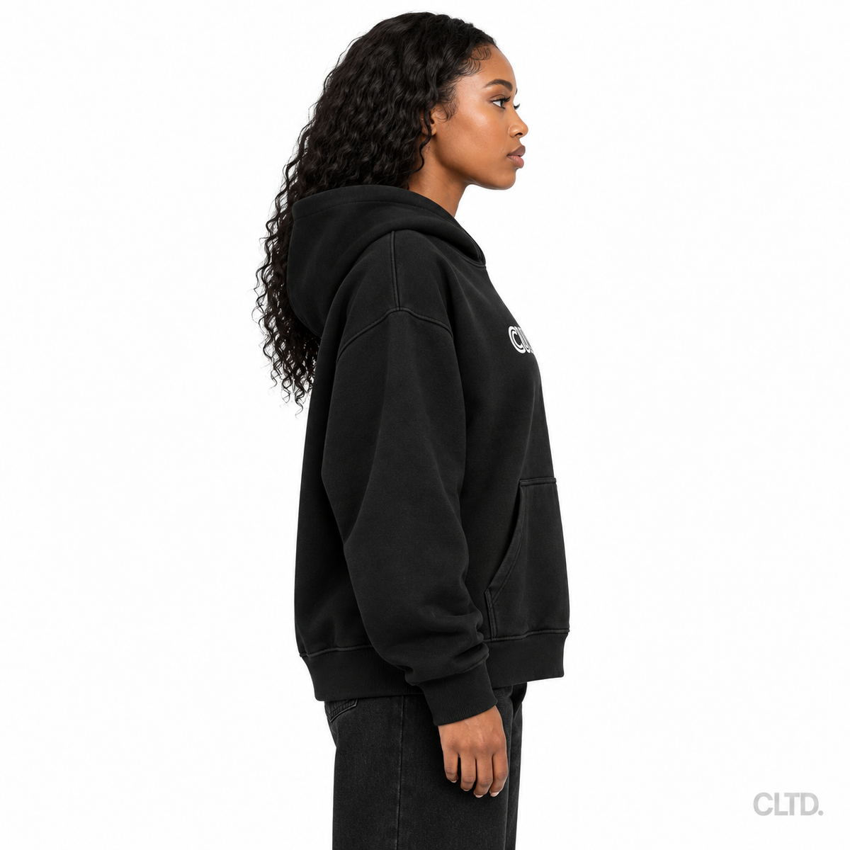 Female model wearing Cultured black heavyweight hoodie side view with CLTD watermark