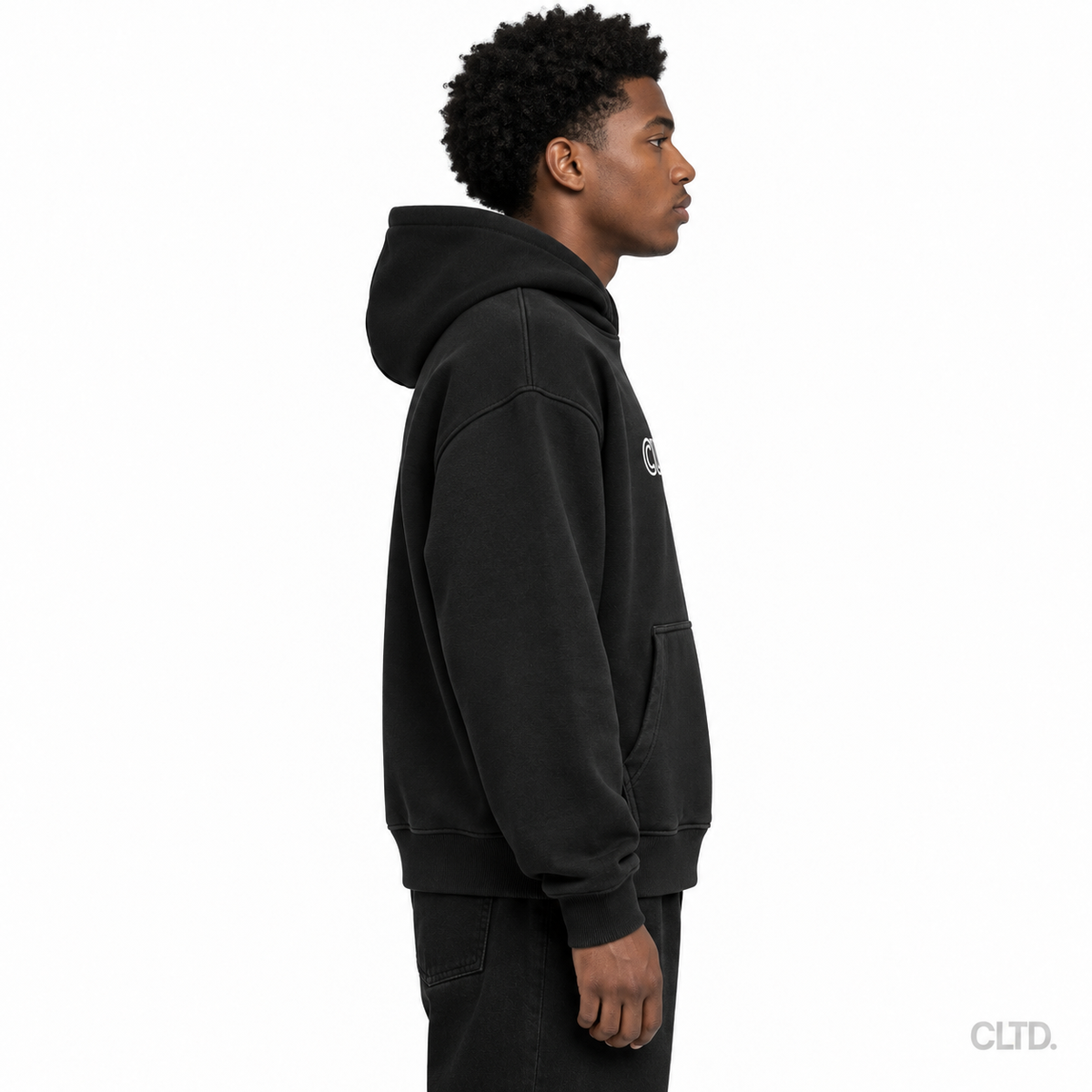 Male model wearing Cultured black heavyweight hoodie side view with CLTD watermark