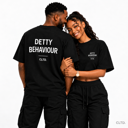 Detty Behaviour — smiling duo showing T-shirt back and crop top front
