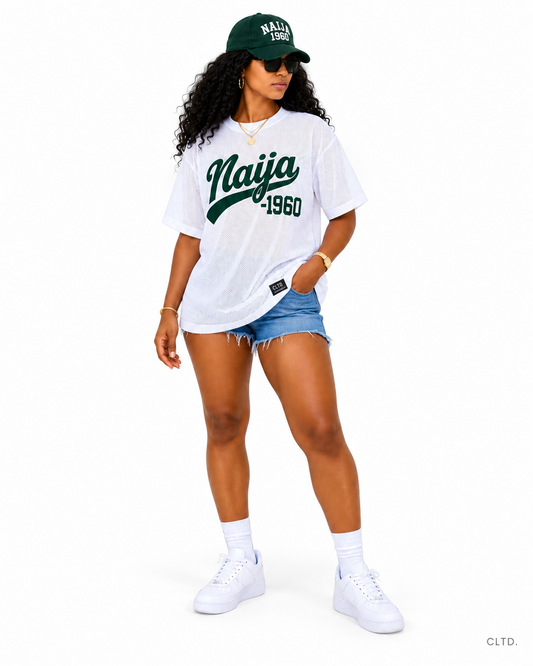 Woman wearing the Naija 1960 white mesh jersey and green Naija 1960 cap on a white background